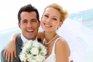 Cheerful married couple standing on the beach